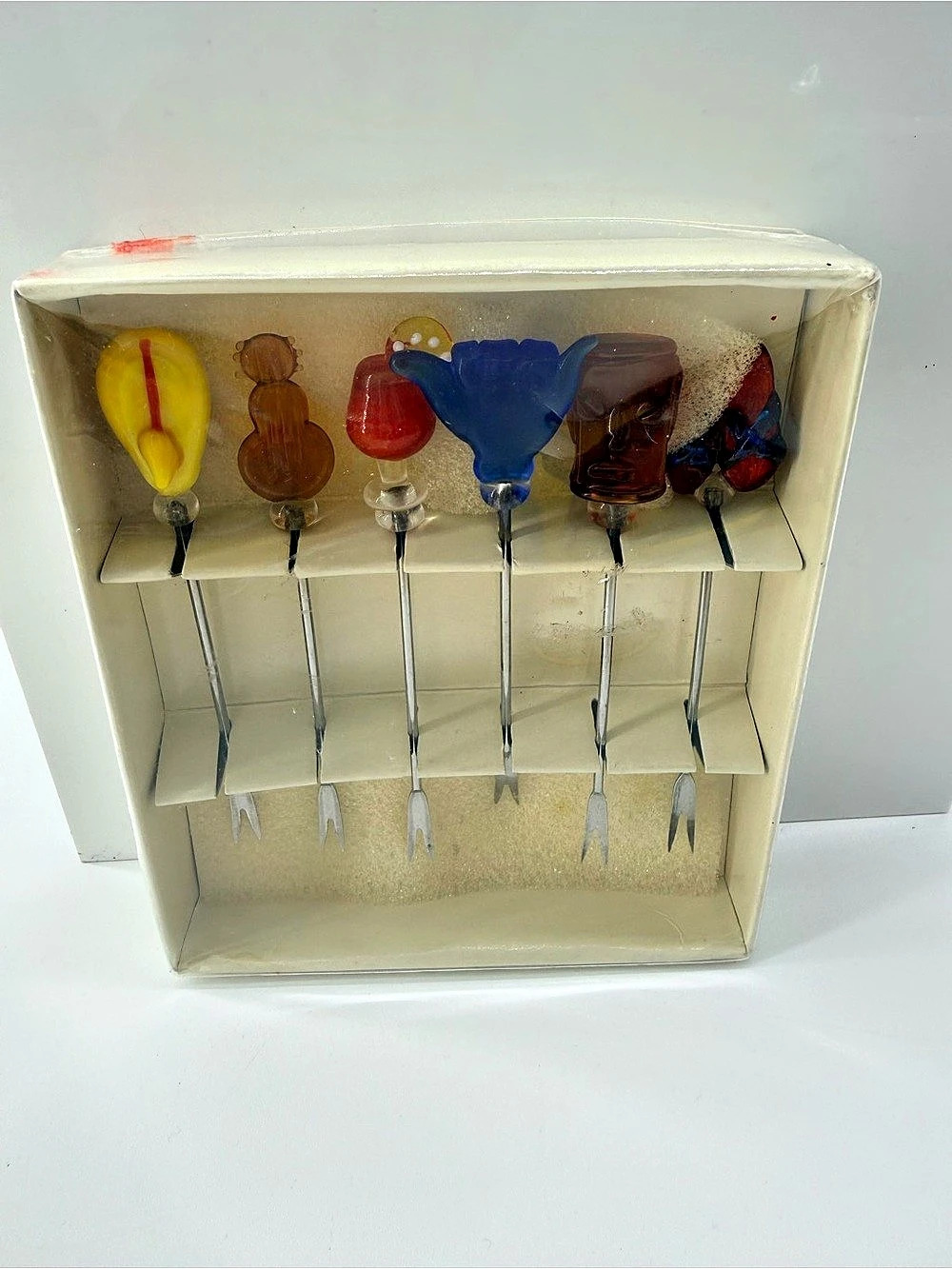 Set of six vintage blown glass cocktail picks with colorful, shape glass